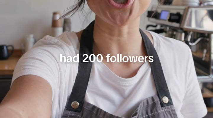 Caption reading “had 200 followers” over a coffee shop owner